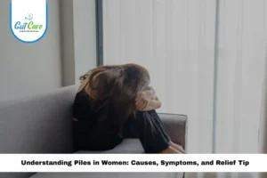 Woman sitting in discomfort on a couch, symbolizing pain and symptoms of piles in women.